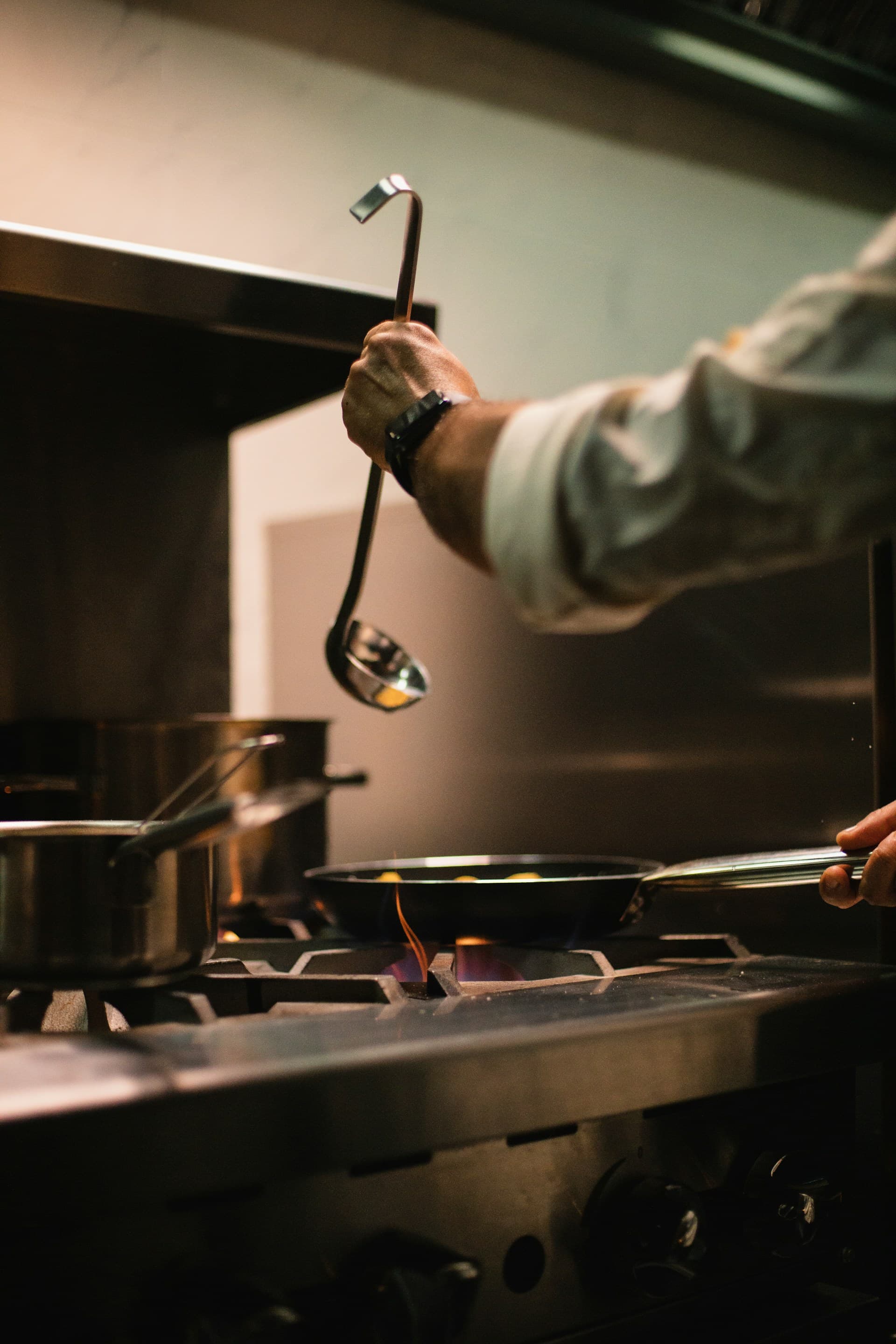 Cooking over open flame in the House of Nelle professional kitchen