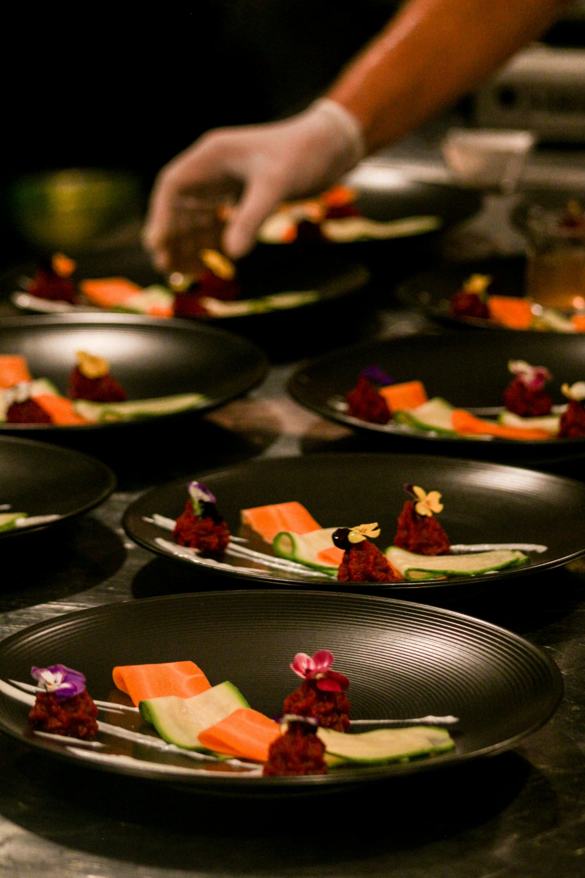 Beautifully plated dishes with edible flowers — luxury event catering London