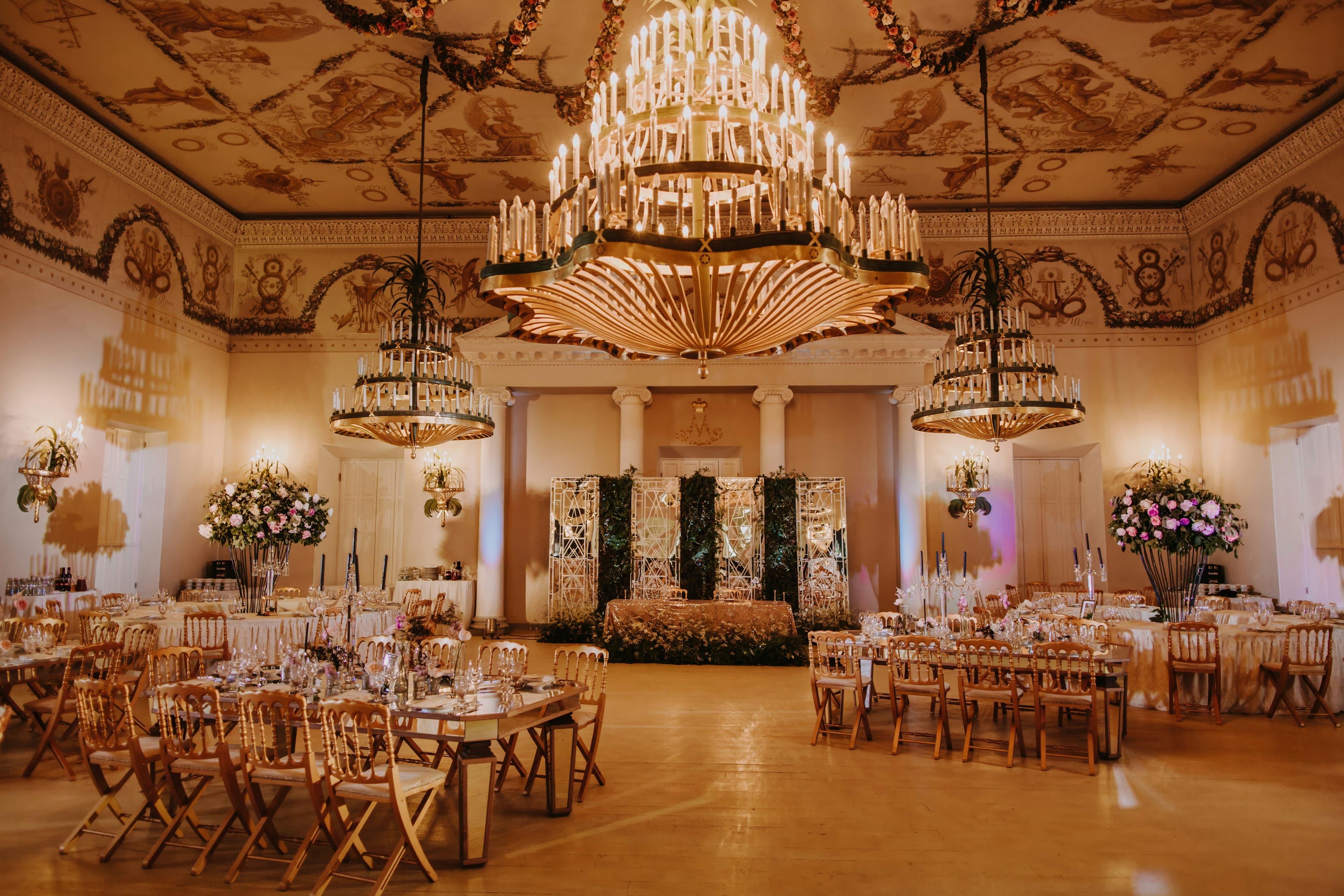 Elegant wedding reception table setting with floral arrangements and fine dining place settings by House of Nelle